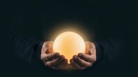 Hands holding glowing orb against dark background, symbolizing energy, innovation, and future potential for business, technology, and creative concepts.