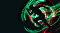 Dynamic silhouette of athletic person jumping with vibrant green and red light trails creating energetic motion blur effect on dark background.