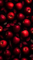 Fresh red apples scattered with fallen leaves on dark background create dramatic contrast and moody atmosphere for food photography and harvest season designs.