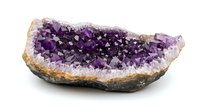 Raw amethyst crystal cluster with deep purple crystalline formation showing natural geode cavity structure on white background, mineral specimen for collectors.