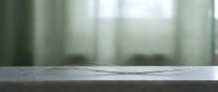 Blurred interior background with empty concrete surface in foreground, suitable for product placement, mockups, and design overlays.