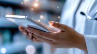 Close-up of medical professional hands holding digital tablet in hospital environment with blurred bokeh lights and modern medical equipment background.