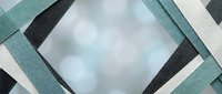 Geometric abstract composition with interlocking teal, charcoal, and white paper strips creating a modern frame around soft blurred background. Suitable for contemporary design projects.