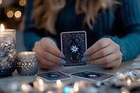 Mystical tarot reading scene with glowing candles and fortune telling cards featuring celestial designs, creating magical atmosphere for divination practice.