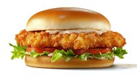 Crispy chicken sandwich with fresh lettuce and tomato on toasted bun, isolated on white background for restaurant menu and food advertising designs.