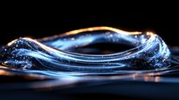 Mesmerizing blue liquid wave formation with golden light highlights against dark background creates dramatic contrast and flowing motion effect in macro photography.