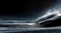 Dynamic snow particles swirling across dark winter landscape with dramatic lighting effects creating abstract motion blur patterns for creative projects.