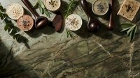 Organic cosmetics and natural skincare products arranged with fresh herbs and botanical ingredients on marble surface for beauty and wellness branding.