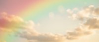 Dreamy pastel rainbow sky with soft fluffy clouds in pink, yellow, green and blue hues creating magical ethereal atmosphere for peaceful meditation backgrounds.