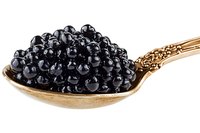 Black caviar on vintage golden spoon against white background, luxury gourmet food close up, isolated delicacy for fine dining and gastronomy.