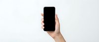 Hand holding black smartphone with blank screen isolated on white background for mockup and app presentation purposes.
