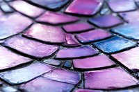 Abstract iridescent dragon scales texture in purple pink and blue holographic colors with metallic shimmer effect for fantasy design backgrounds.