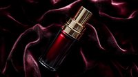 Luxurious dark red cosmetic bottle on black silk fabric with dramatic lighting, elegant product photography for beauty and skincare advertising campaigns.