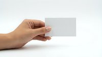 Hand holding blank white business card mockup on clean background for branding and corporate identity design projects.