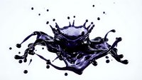 Dynamic purple liquid splash with crown formation and droplets isolated on white background for creative design projects.