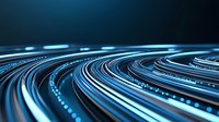 Glowing blue light trails curve into distance creating dynamic motion effect against dark background, representing digital data flow and high-speed connectivity.