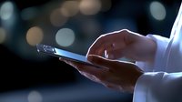 Female hands holding smartphone in dark environment with blurred bokeh lights background, side view close up showing modern technology use.