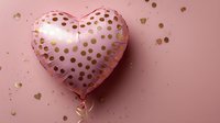 Pink heart-shaped foil balloon with gold polka dots on pastel pink background with scattered gold confetti. Perfect for celebration designs.