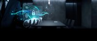 Businessman holding holographic cybersecurity interface with digital lock and data protection elements in modern office environment for technology concepts.