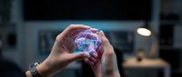 Hands holding glowing holographic reset button in modern office environment for technology and digital transformation concepts.