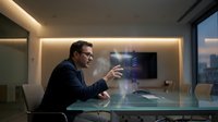 Professional businessman in suit using holographic technology interface in modern office conference room with ambient lighting and city view.