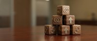 Wooden blocks stacked in pyramid formation with copyright and trademark symbols, representing intellectual property, licensing, and legal protection concepts for business and design.