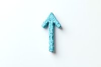 Textured light blue upward arrow symbol made from rough material casting soft shadow on white background, isolated design element for creative projects.