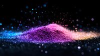 Colorful glitter powder explosion on black background with blue, purple and pink sparkles creating magical wave effect. Macro photography of shimmering dust.