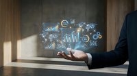 Businessman in dark suit holding tablet displaying glowing financial analytics charts, graphs, and network icons for business intelligence and data visualization applications.