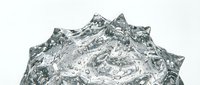 Crumpled metallic foil texture with reflective silver surface and sharp angular peaks, isolated on white background for design projects.