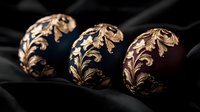 Luxurious wide cuff bracelets with ornate gold floral filigree pattern on dark blue and burgundy enamel background, displayed on black silk fabric.