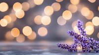 Fresh lavender sprigs with warm golden bokeh lights creating romantic ambiance for spa, aromatherapy, wellness, and relaxation concepts.