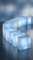 Row of glowing translucent ice cubes with blue light illumination on reflective surface creating modern minimalist atmosphere for technology concepts.