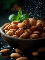 Fresh almonds in wooden bowl with water drops and basil leaf on dark background, macro food photography for healthy eating and nutrition concepts.