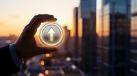 Hand holding glowing upward arrow button against city skyline at sunset, symbolizing business growth, investment success, and financial progress.