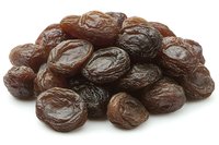 Pile of dried dates isolated on white background. Sweet brown fruit snack rich in nutrients and fiber for healthy eating and cooking.