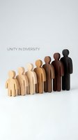 Wooden figures in varying skin tones arranged in a line, representing diversity, inclusion, and unity. Suitable for corporate communications, diversity initiatives, and social concepts.