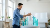 Young Caucasian businessman in blue shirt presenting growth chart with upward arrows in modern office during business meeting or training session.