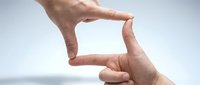 Hands forming frame gesture against blurred background for creative composition and visual storytelling in photography and design projects.