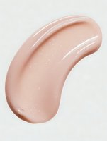 Smooth peach-colored cosmetic cream smear with subtle shimmer on white background, showcasing texture for skincare or makeup product.