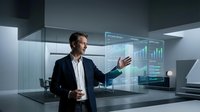 Caucasian male professional in dark business suit presenting financial data on holographic display screen in modern office environment for corporate presentations and technology concepts.