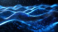 Glowing blue particle waves flow across dark background with shimmering dots creating dynamic motion effect in space. Abstract digital art for technology concepts.