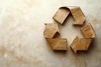 Recycling symbol made from brown kraft paper arrows arranged in circle on textured beige background, representing eco-friendly sustainability concept.