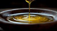 Golden oil streams into a dark bowl, creating concentric ripples and waves in liquid form. Suitable for culinary, wellness, and cooking-related projects.