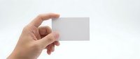 Hand holding blank business card isolated on white background, ready for custom branding and corporate design mockup.