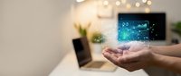 Smart home technology concept with hands presenting digital network connections in modern living room with laptop and ambient lighting for IoT applications.