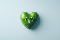 Green heart with heartbeat pulse line on light blue background, symbolizing healthy lifestyle, wellness, and environmental care.