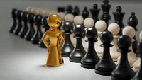 Golden trophy figure standing prominently among chess pieces on board, symbolizing victory, achievement and strategic success in competition.