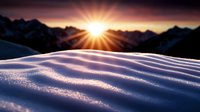 Dramatic sunrise over snow-covered mountain peaks with pristine powder snow drifts creating natural patterns in alpine wilderness landscape for outdoor adventure.
