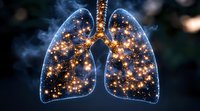 Glowing human lungs filled with sparkling golden lights against dark background, anatomical medical concept with smoke effect and luminous particles.